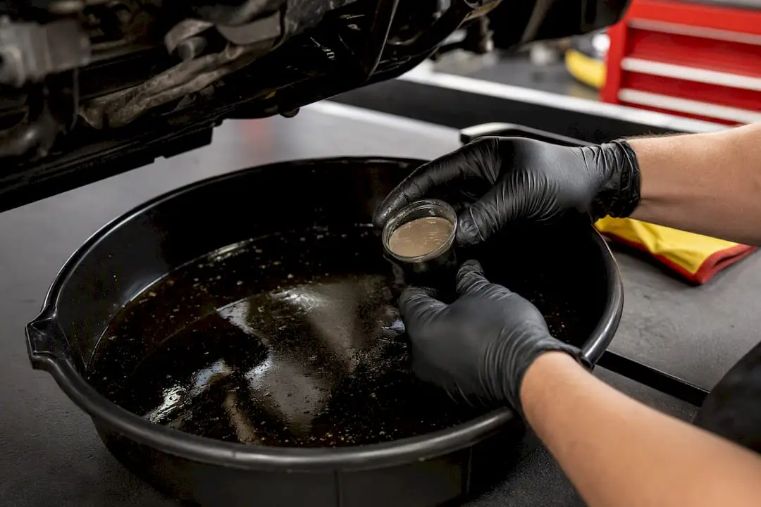 Technician inspecting contaminated engine oil