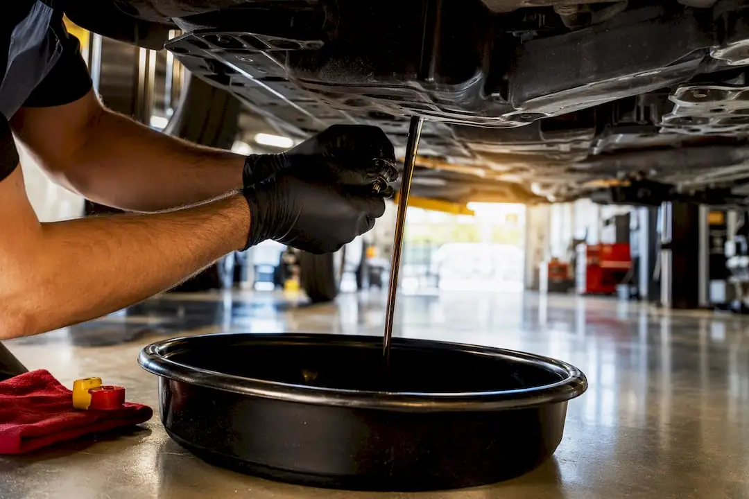 Technician performing an oil change