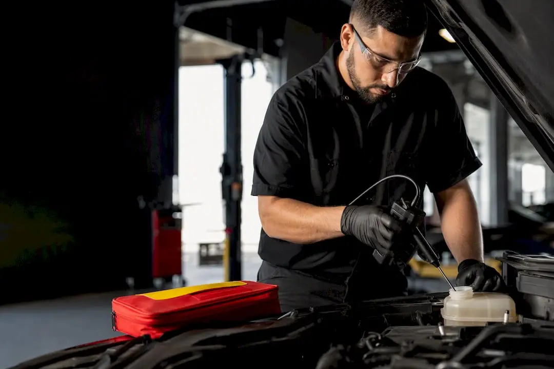 Technician testing brake fluid moisture