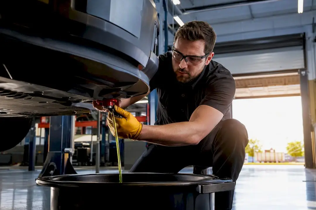 Technician performing vehicle coolant service