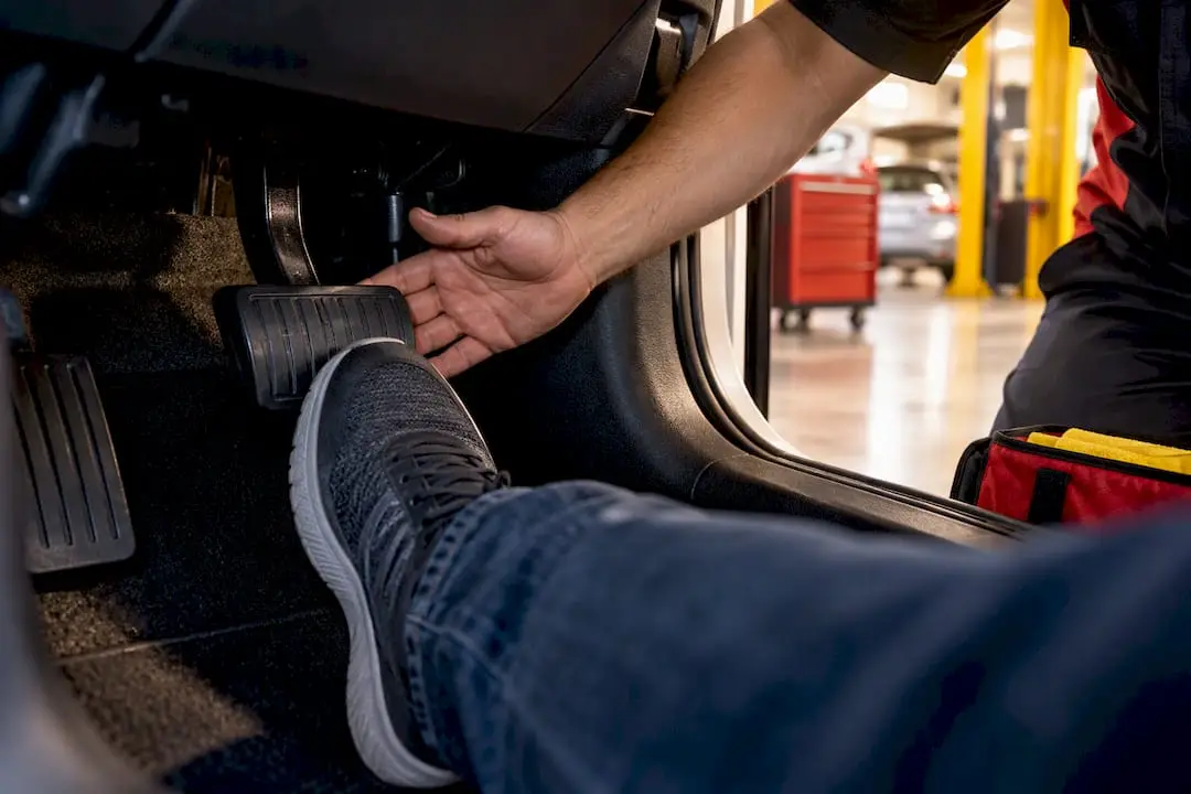 Foot pressing a soft brake pedal